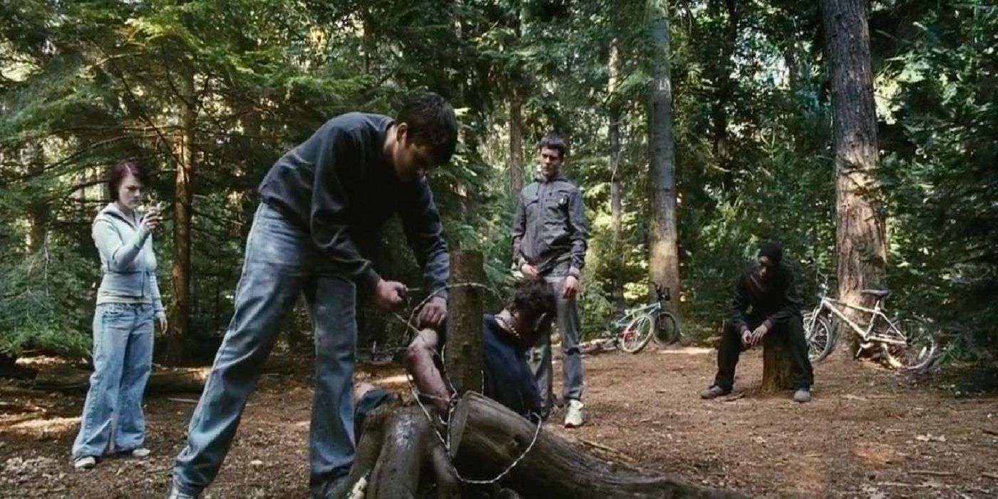 The gang ropes up a person in the woods in Eden Lake
