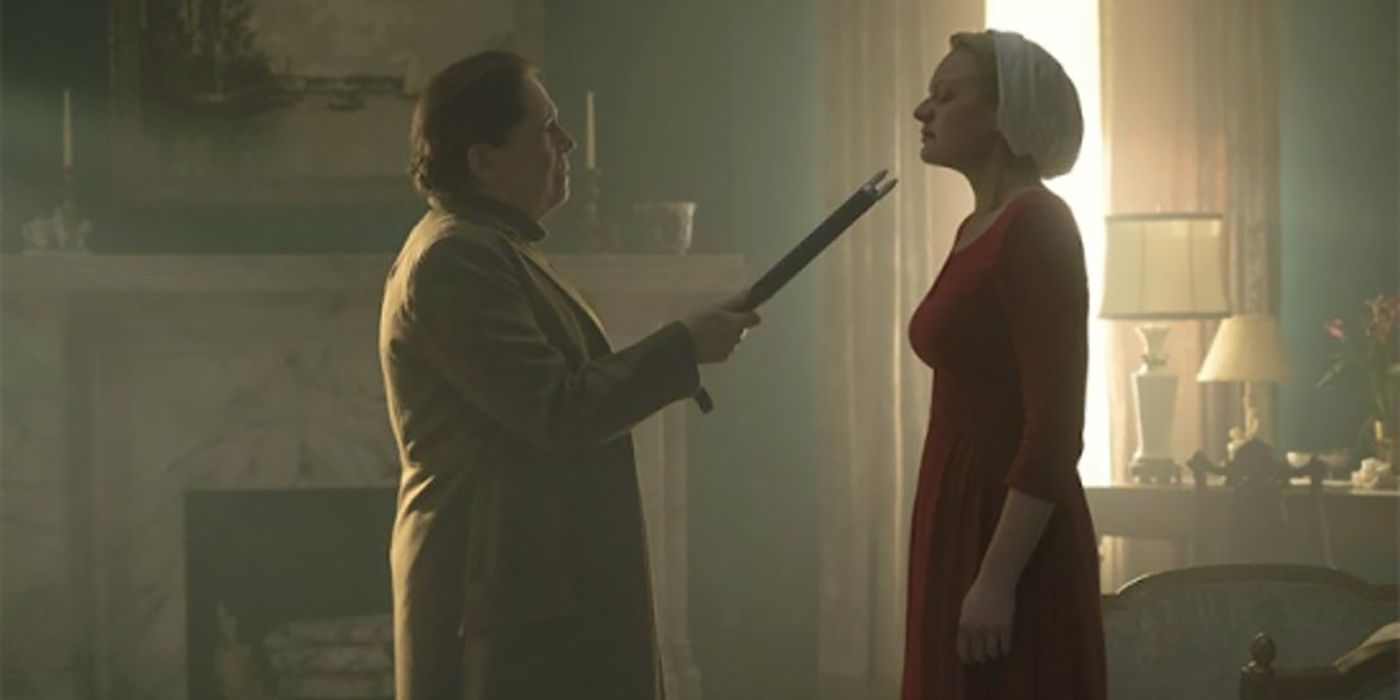 Aunt Lydia pointing a cattle prod at June in The Handmaid's Tale