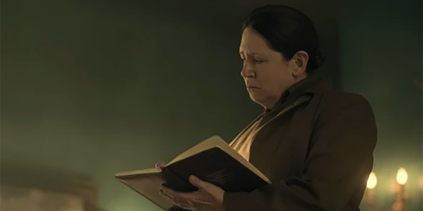 Aunt Lydia reading from a book in The Handmaid&rsquo;s Tale