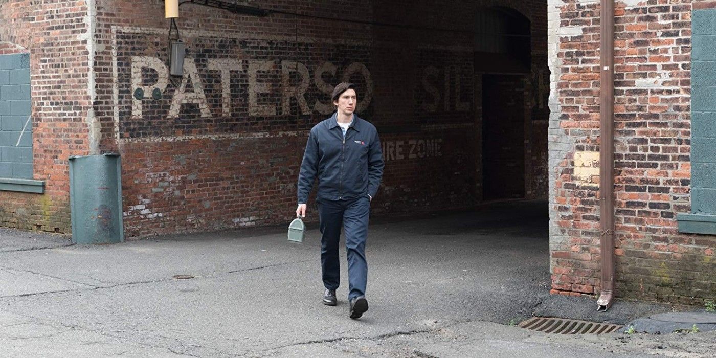 Paterson walks by a train station sign