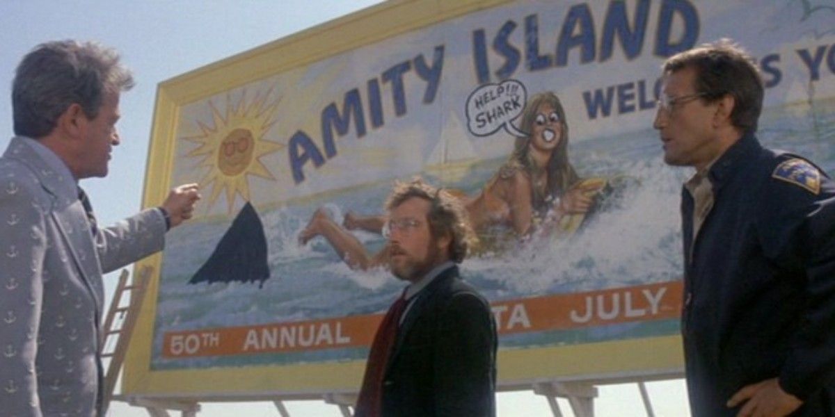 Vaughn, Hooper, and Brody in front of the vandalized Amity sign