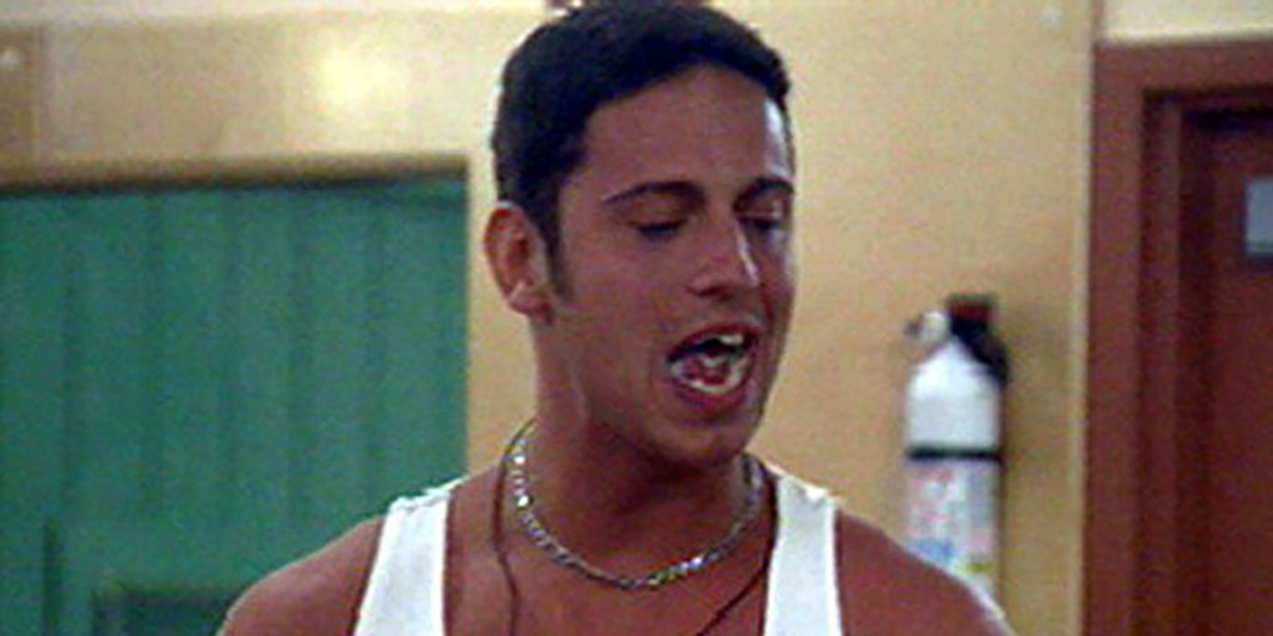 Justin Sebik from Big Brother with his mouth open saying something wearing a white tank top