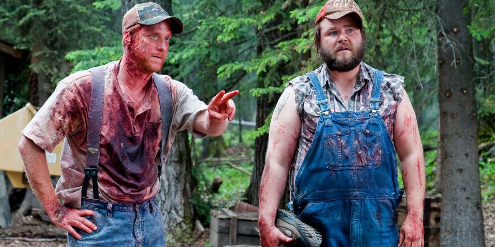 Tucker and Dale covered in blood in the wood in Tucker and Dale vs. Evil