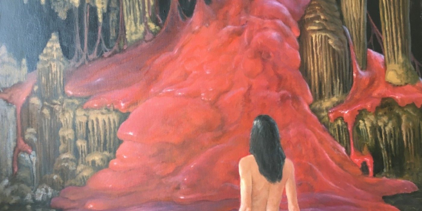 A young woman before a mountain covered on red slime.