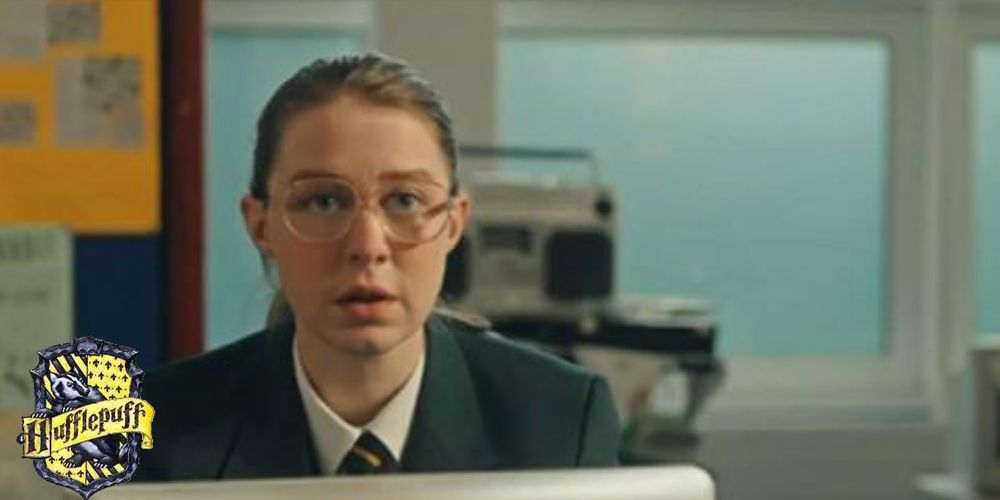 Aisling in Derry Girls with a Hogwarts Hufflepuff house crest in the lower left corner
