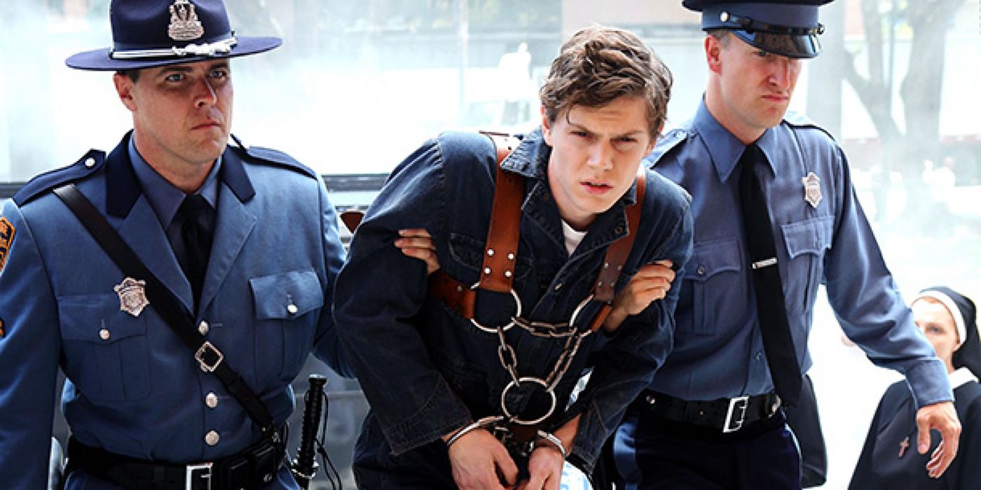Evan Peters handcuffed and being dragged by two policemen in American Horror Story Asylum 