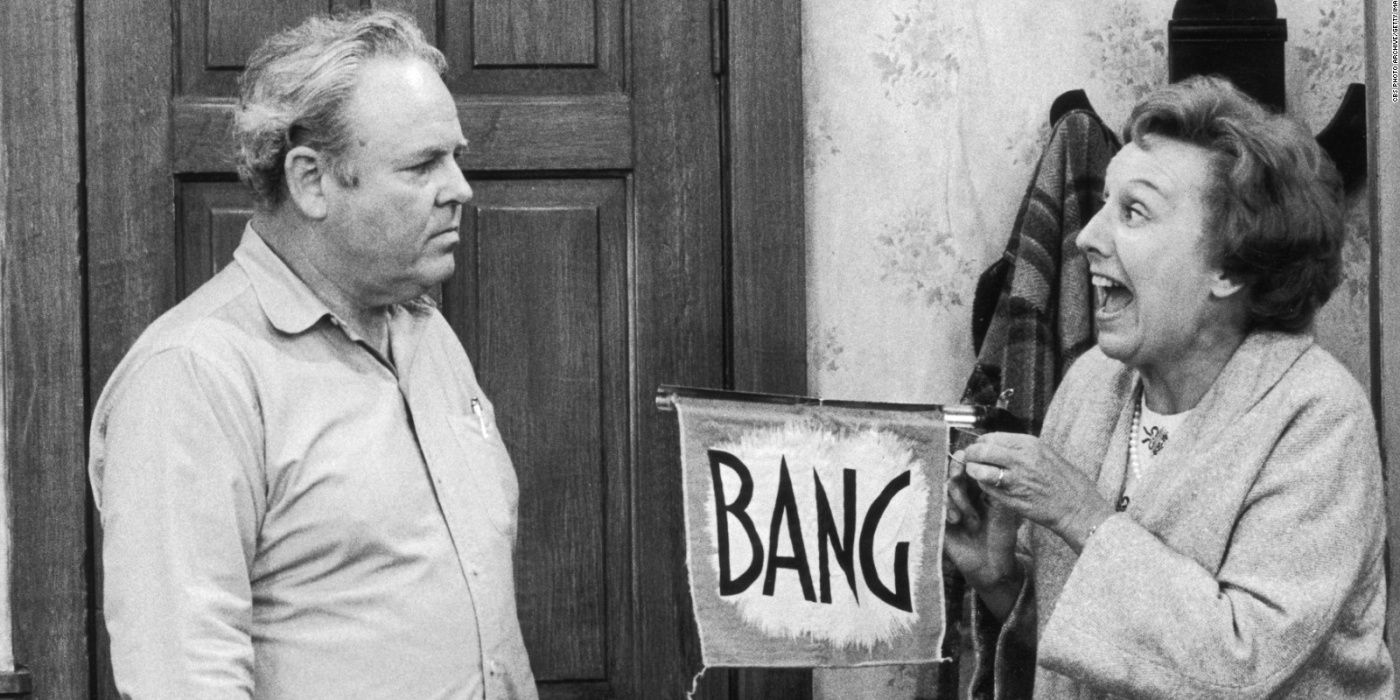 Edith pointing a bang flag at Archie on All in the Family
