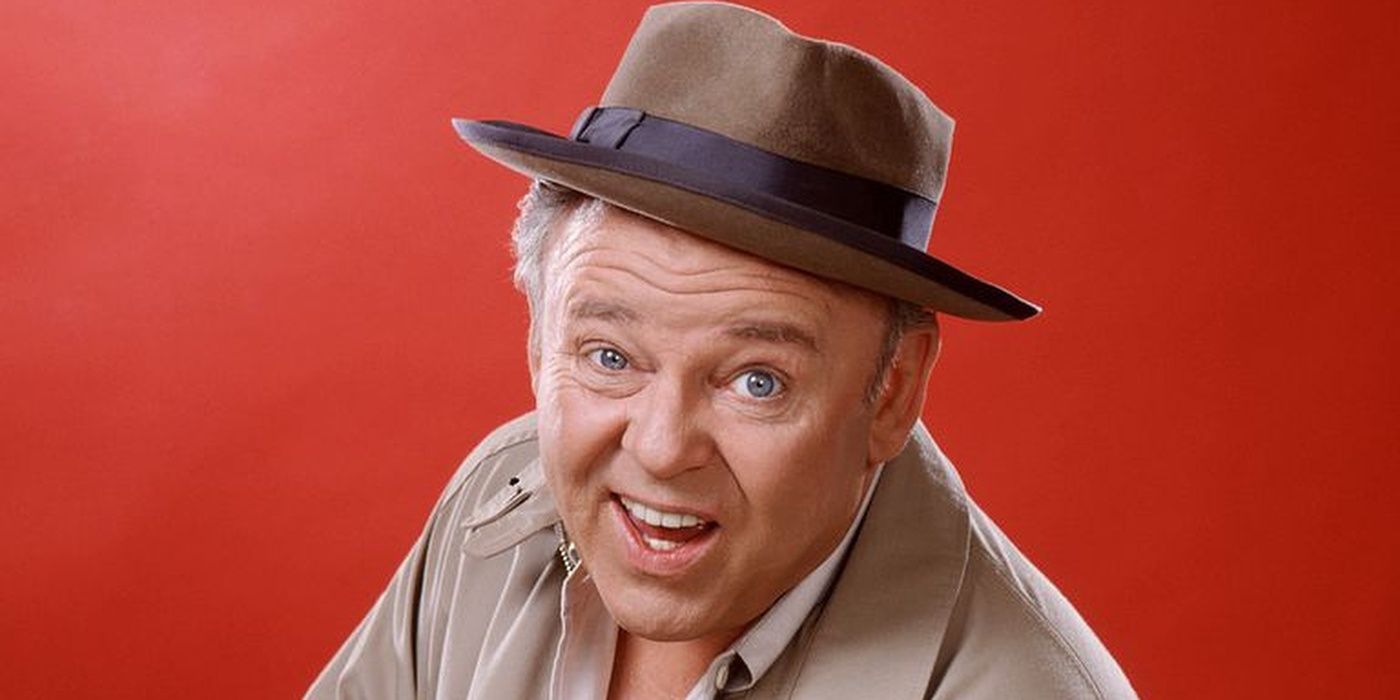 Archie Bunker from All In The Family making a face at the viewer against a red backdrop
