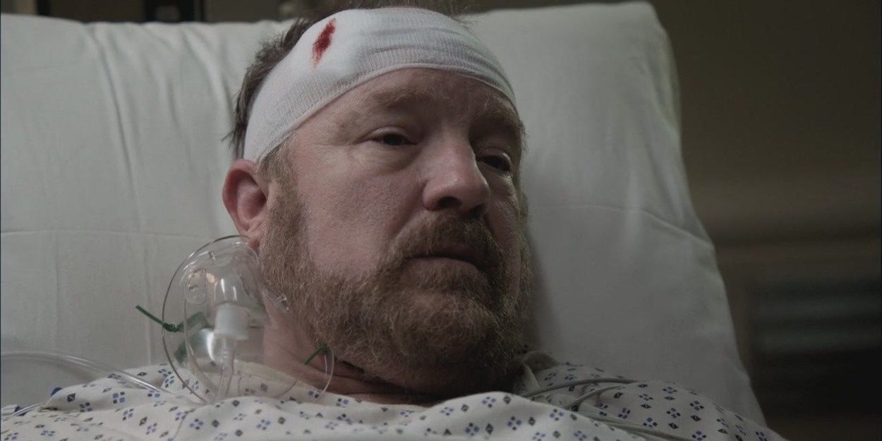Bobby lies in a hospital bed with a gunshot wound in Supernatural