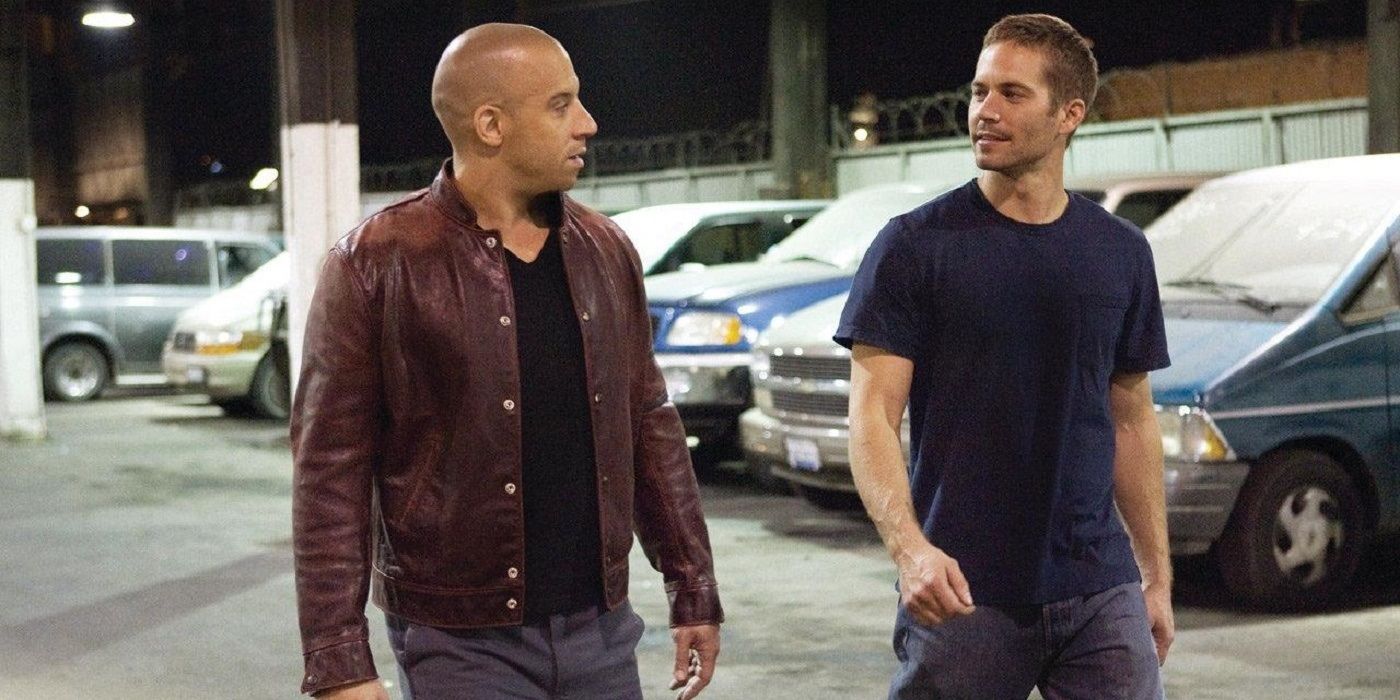 Brian and Dom walk through a parking lot in Fast & Furious