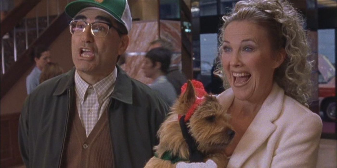 Eugene Levy and Catherine O'Hara lifting a dog and smiling in Show