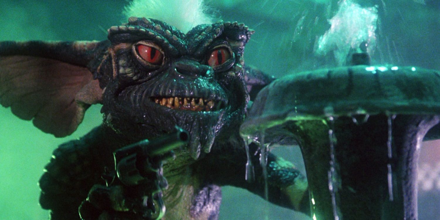 A gremlin stands near a fountain in Gremlins