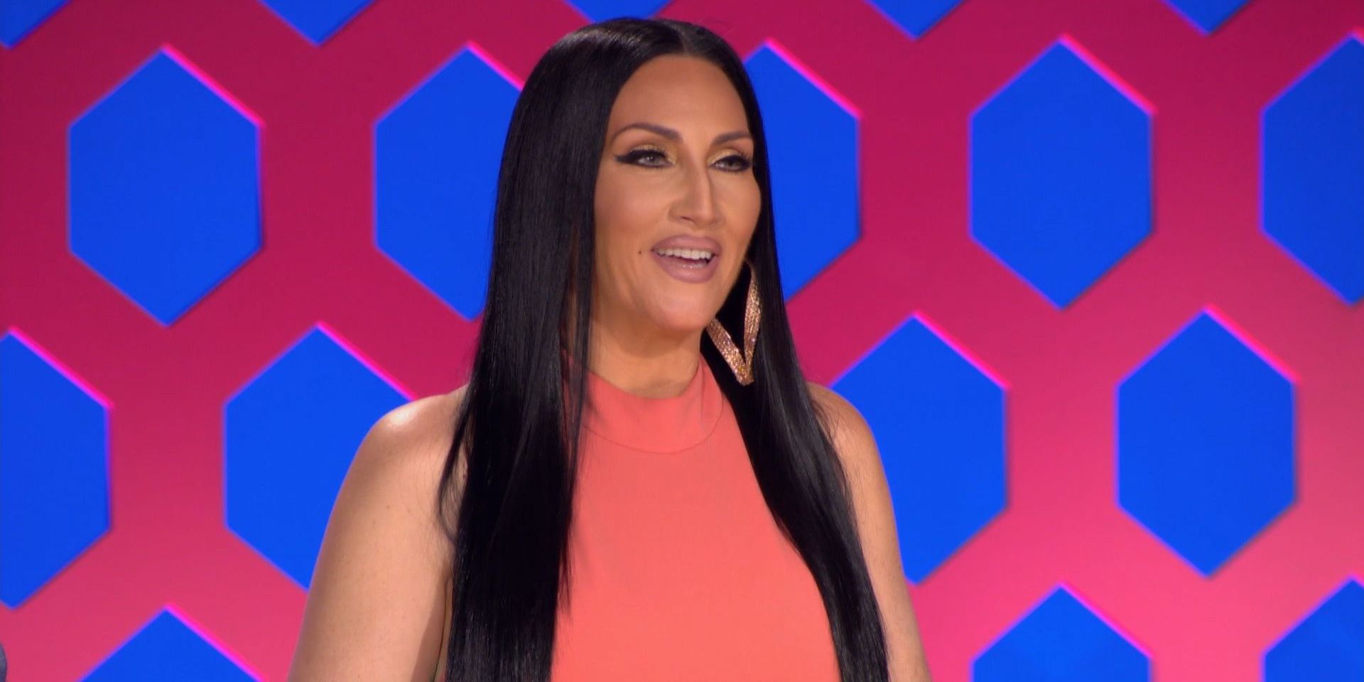 Michelle Visage behind the judges' table on RuPaul's Drag Race