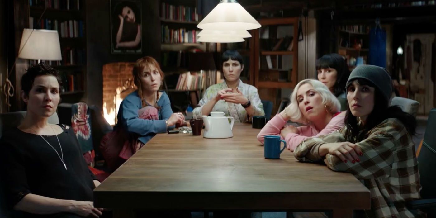 The sisters at a table in What Happened To Monday?