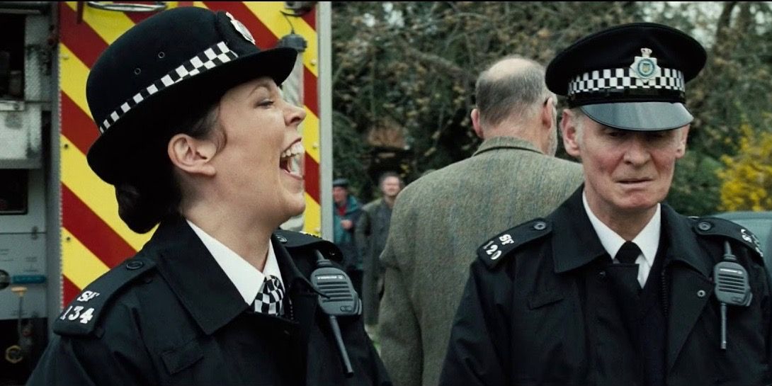 Doris in a police uniform laughing in Hot Fuzz