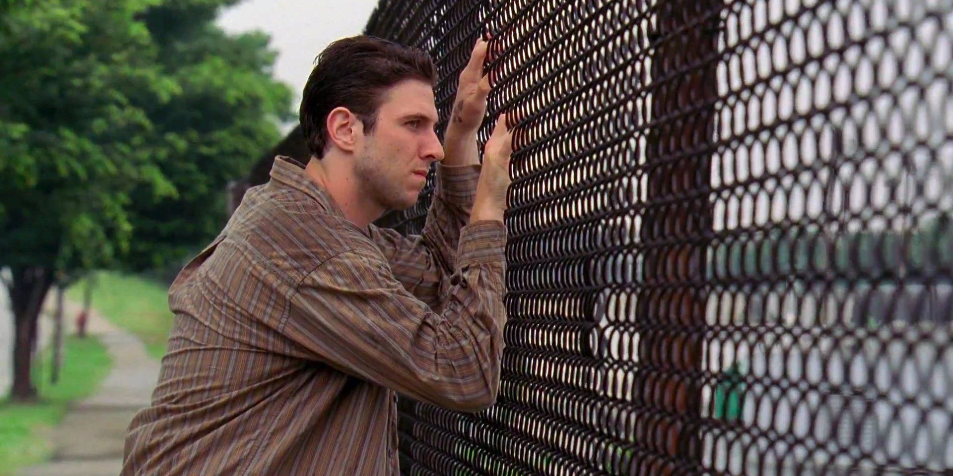 Nicky leaning on a fence in The Wire