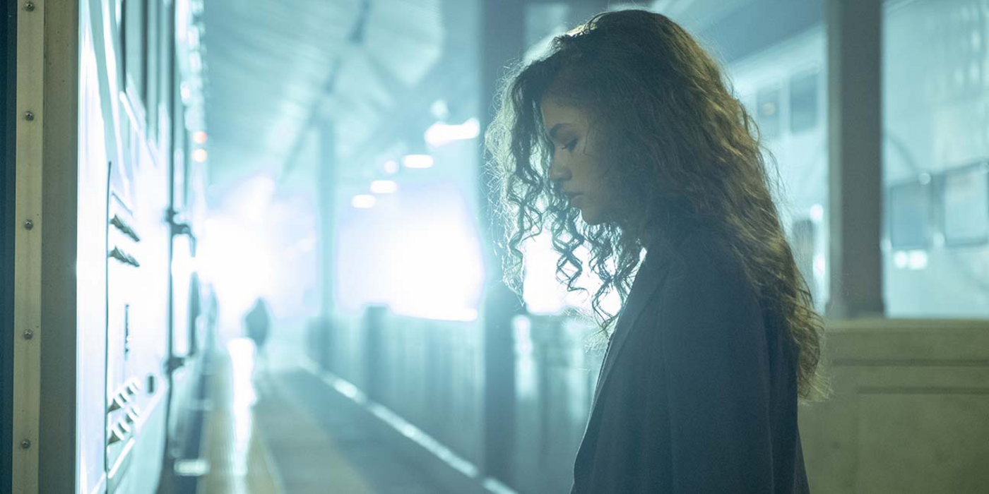 Rue standing in the train station in Euphoria.