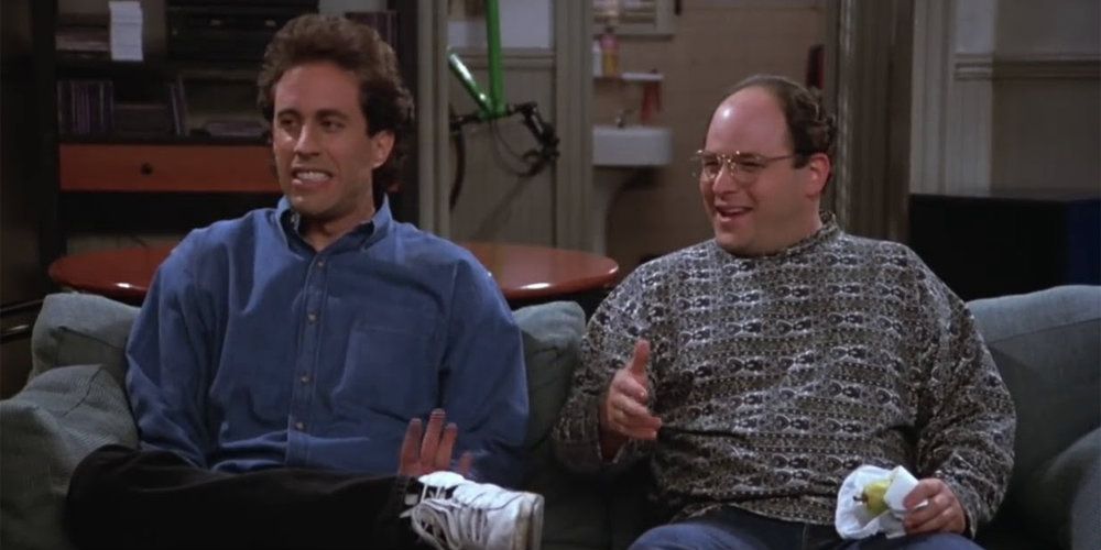 Jerry and George sitting next to each other in Jerry's apartment