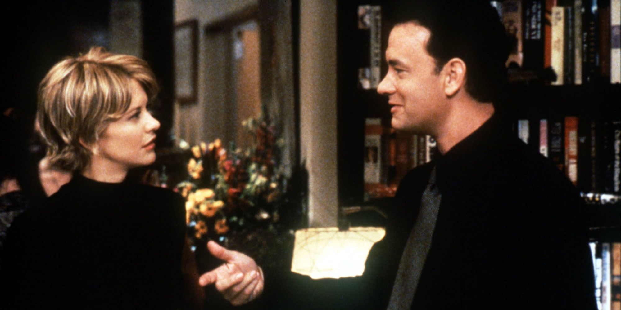 Tom Hanks smiling and looking at Meg Ryan in You've Got Mail