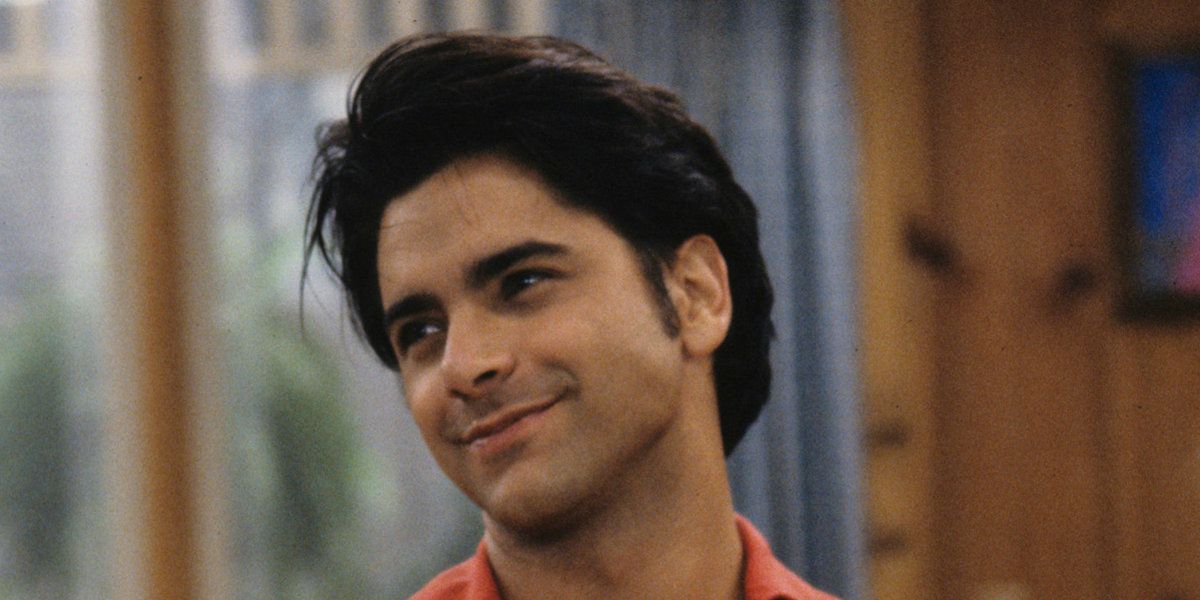 Uncle Jesse smiling at someone in Full House