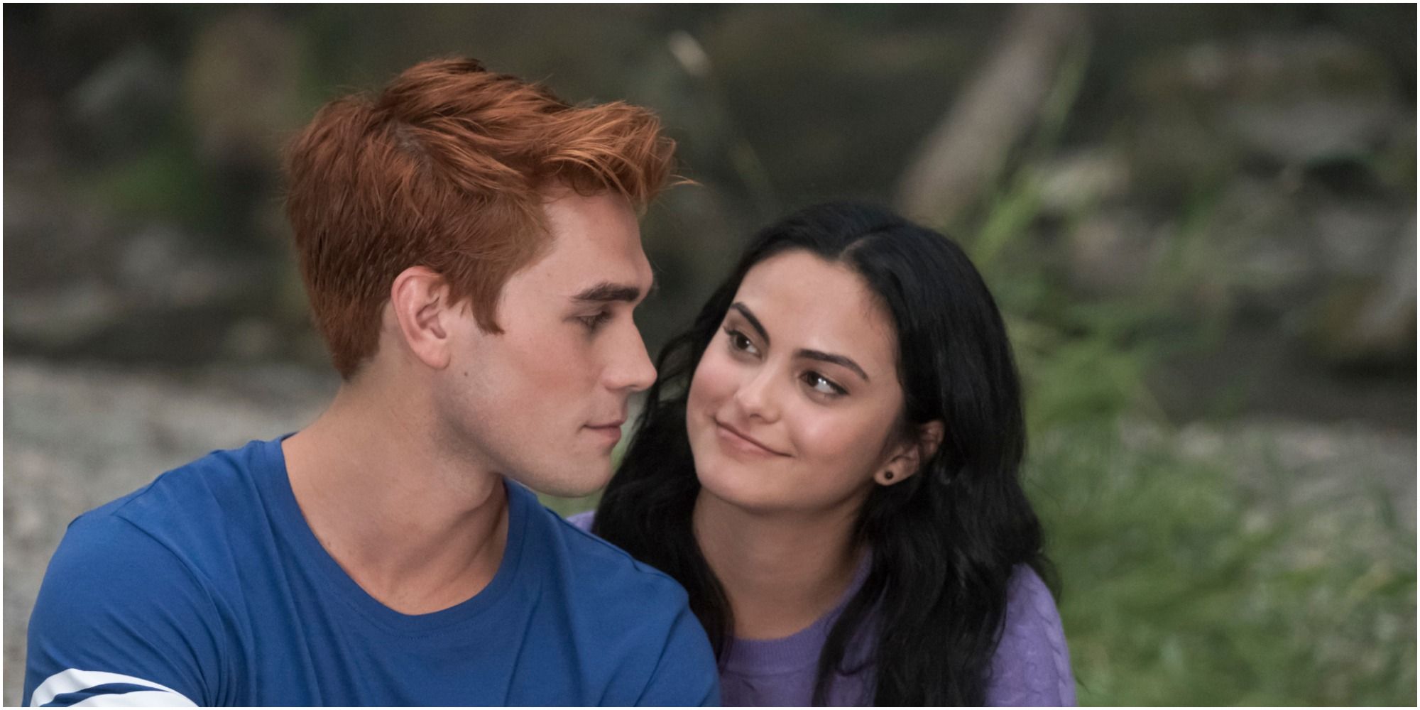 Archie and Veronica sitting together on Riverdale
