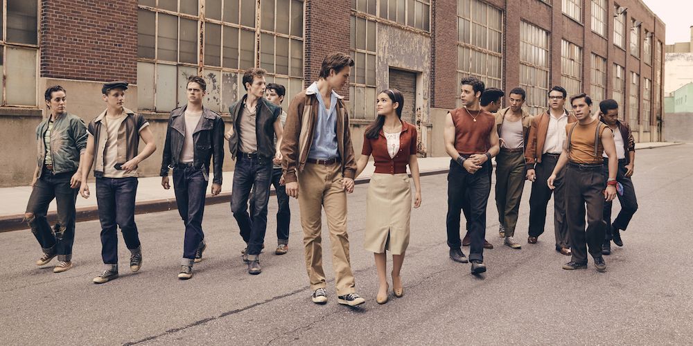 Angel Elgort and Rachel Zegler walking with the gang behind them in West Side Story