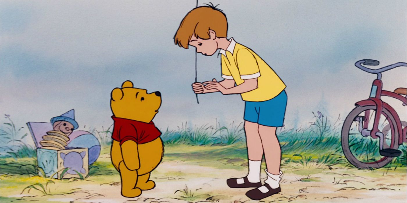 Winnie the Pooh and Christopher Robin with a balloon facing eachother