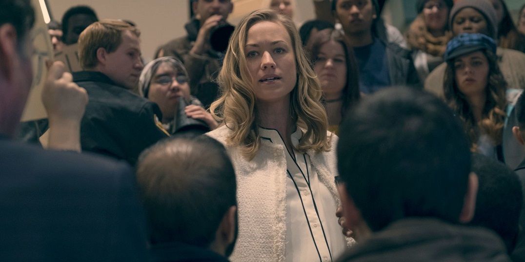 Serena surrounded by a crowd of people in a scene from The Handmaid&rsquo;s Tale.