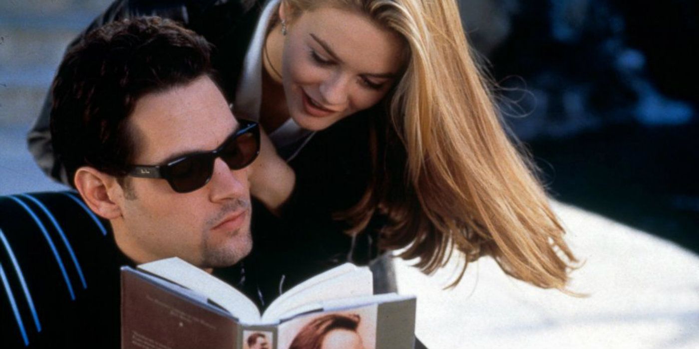 Cher leans over Josh's shoulder while he reads in Clueless