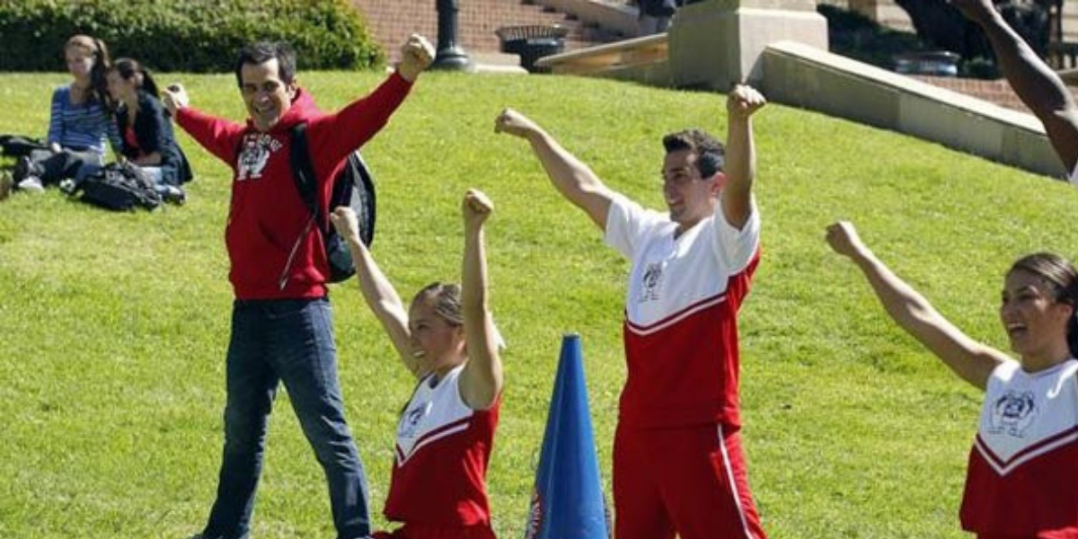 Phil cheering on the field on Modern Family