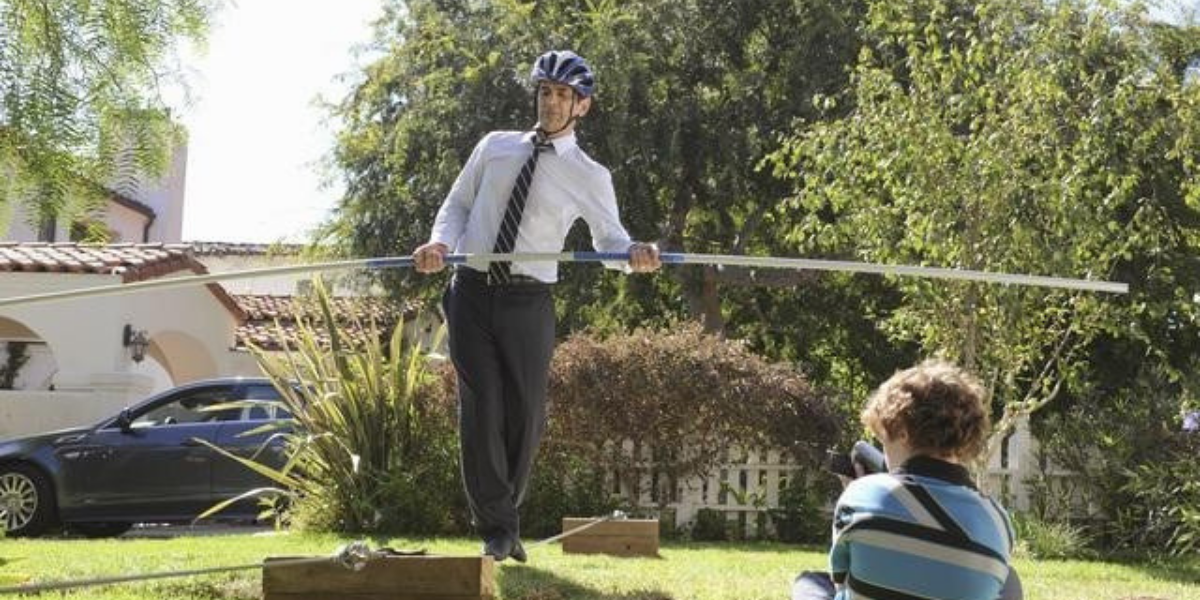 Phil walking on a tightrope on Modern Family