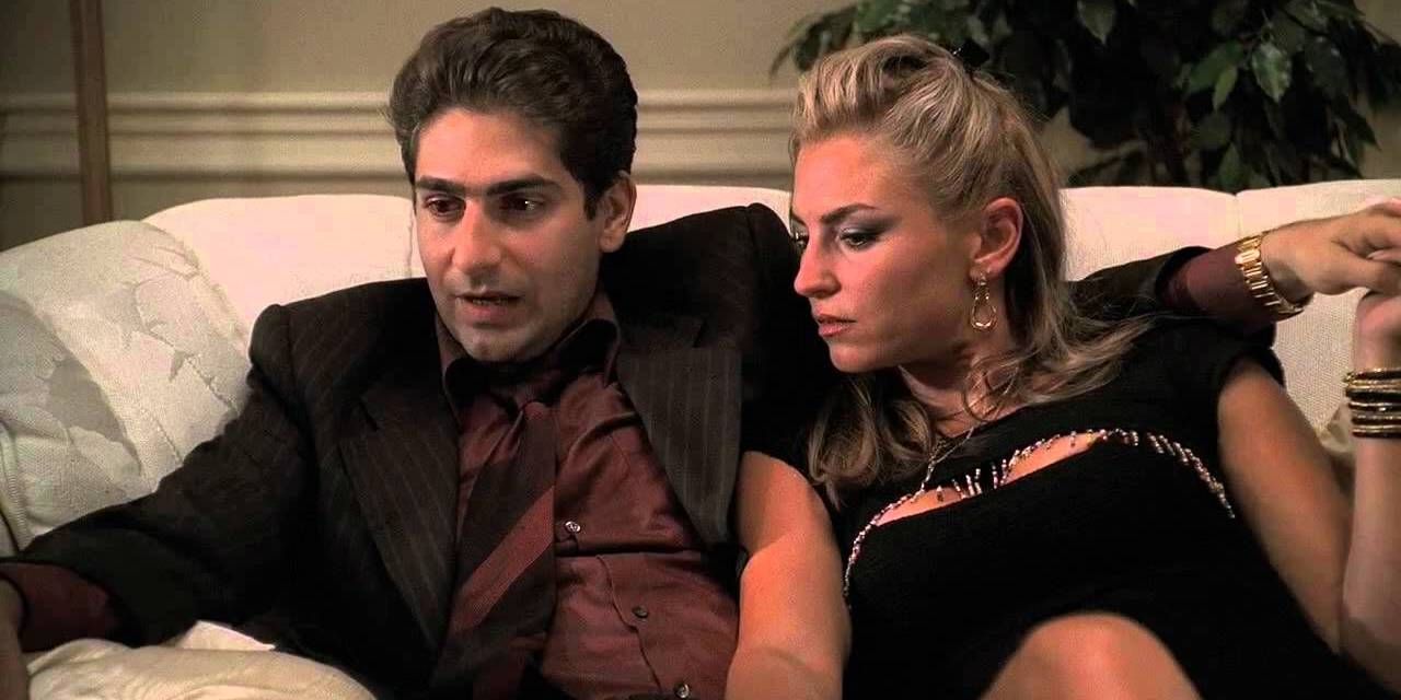 Michael Imperioli as Christopher Moltisanti and Drea de Matteo as Adriana sitting on a couch in The Sopranos