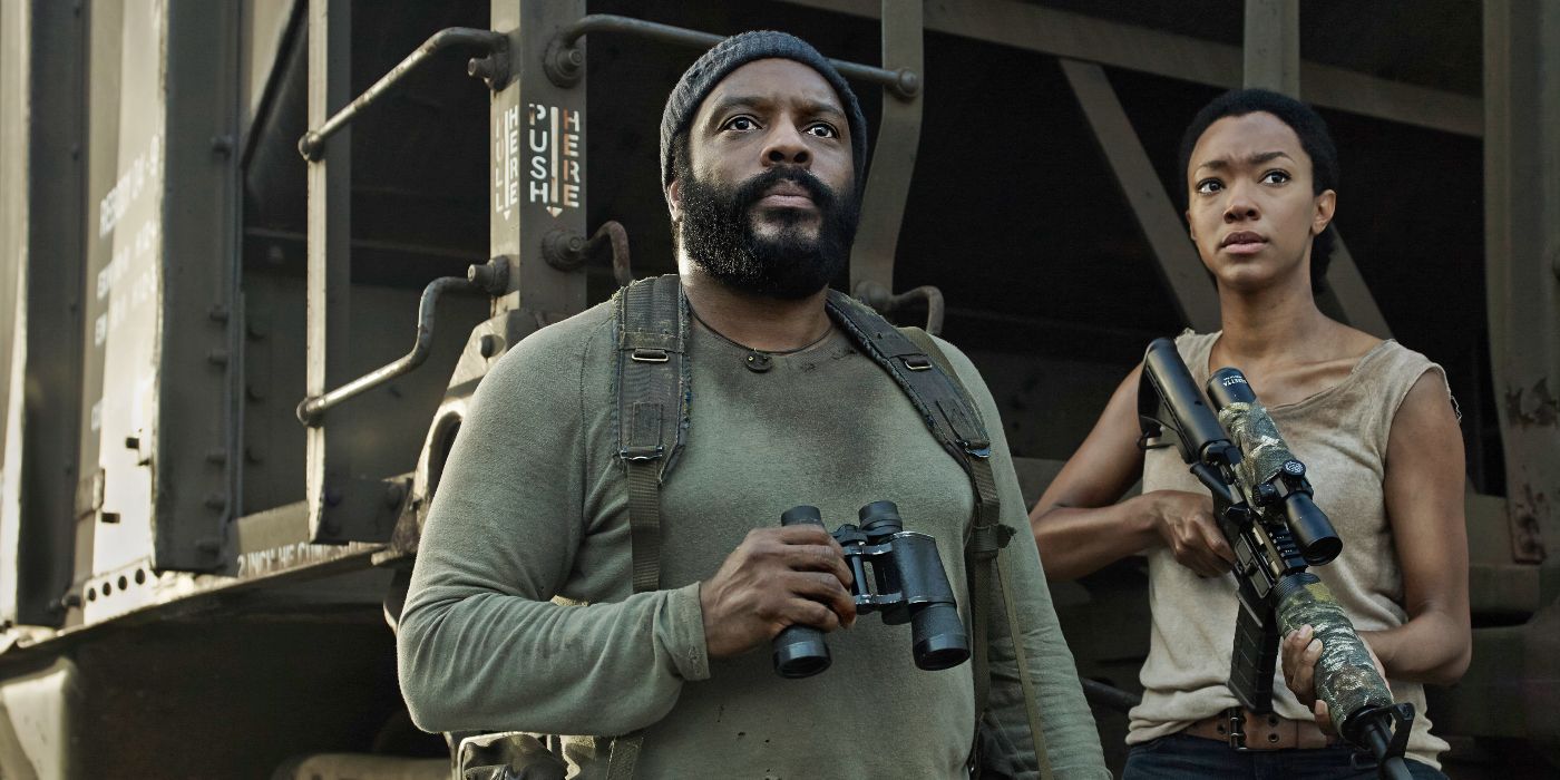 Tyreese holds binoculars while Sasha carries a gun in The Walking DEad.