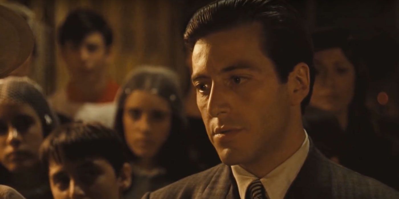 Michael Corleone speaking to a priest at a baptism