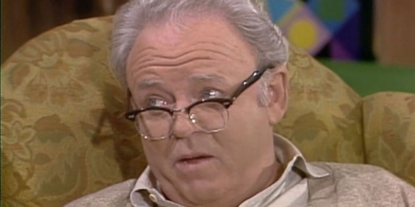 Archie Bunker sitting in his chair and looking over his glasses in All in the Family