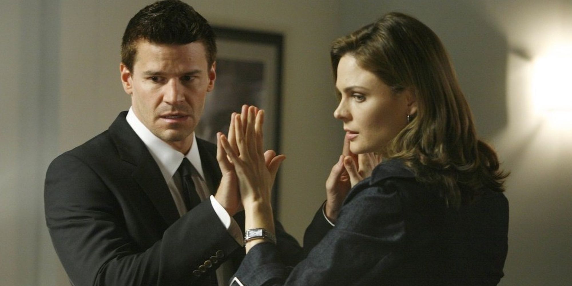 Booth and Brennan joining hands on Bones
