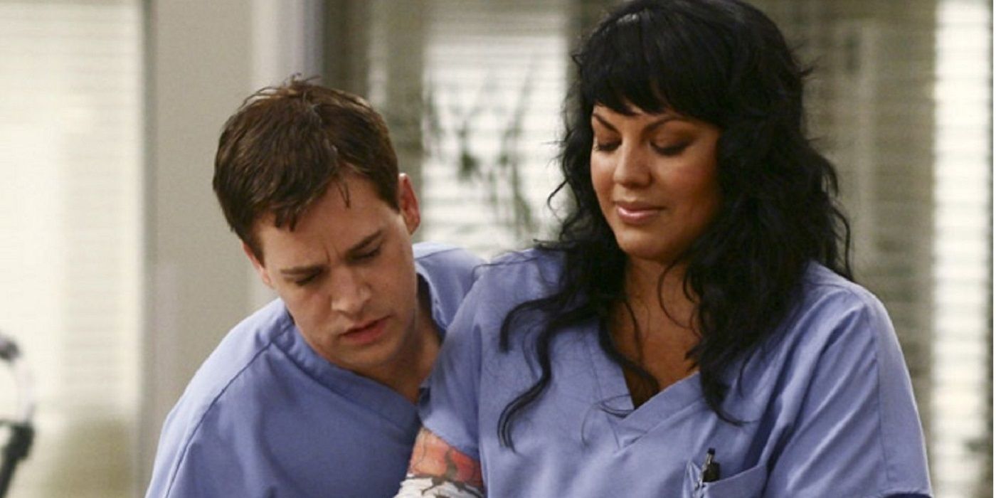 George and Callie wearing blue scrubs at the hospital on Grey's Anatomy