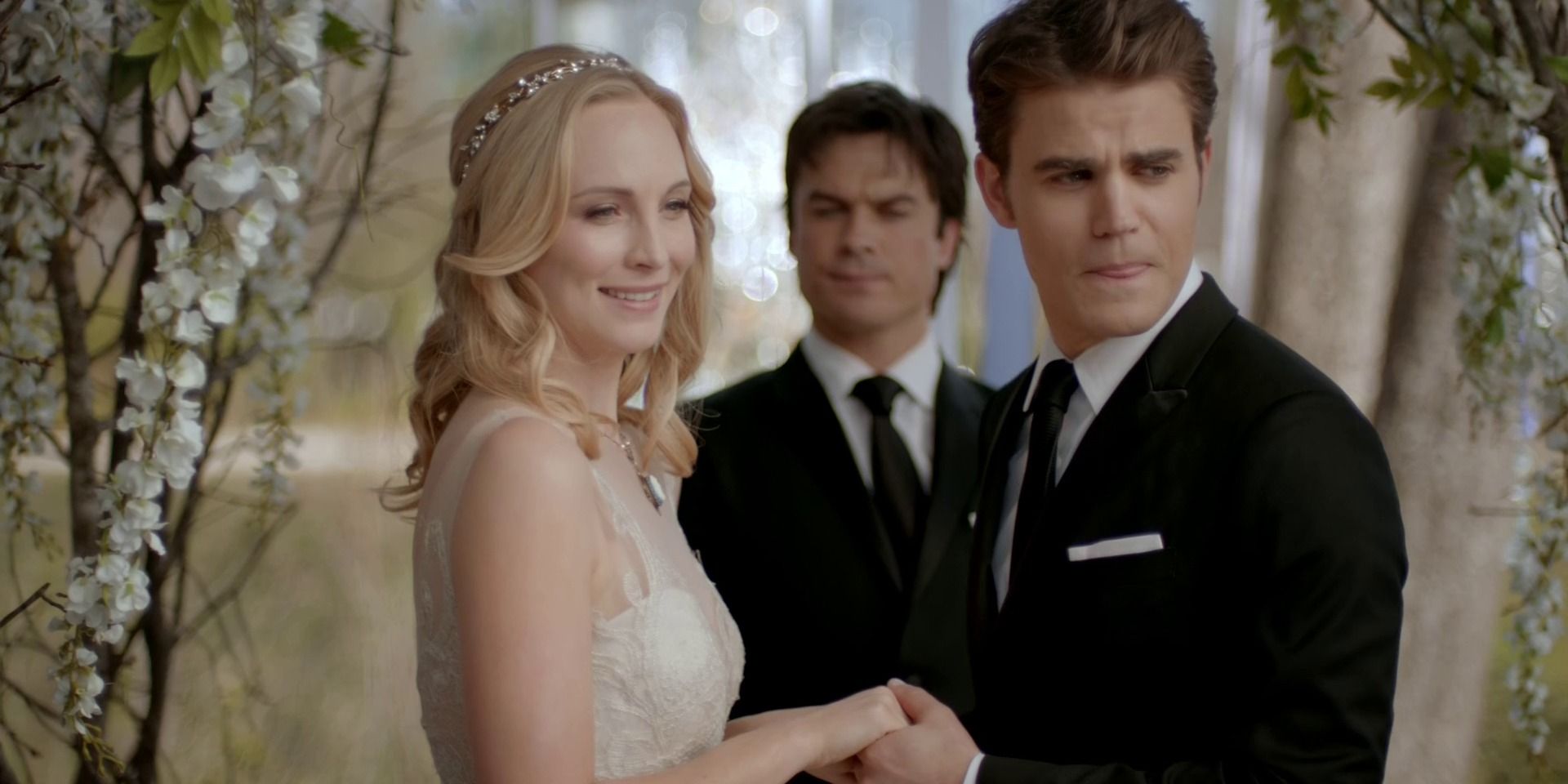 Caroline and Stefan while Damon marries them in The Vampire Diaries
