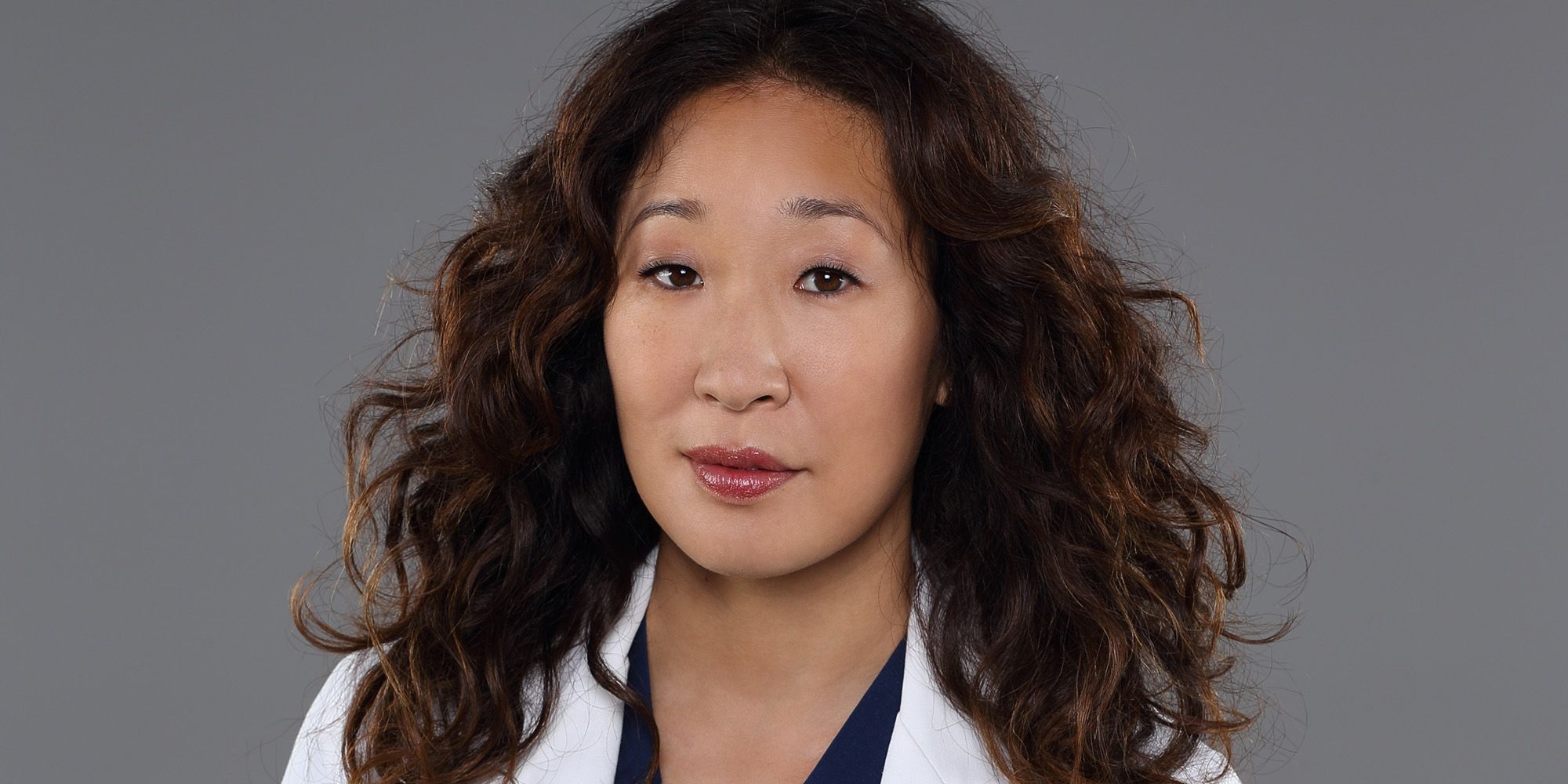 Publicity shot of Sandra Oh as Cristina Yang in her doctor outfit in Grey's Anatomy.