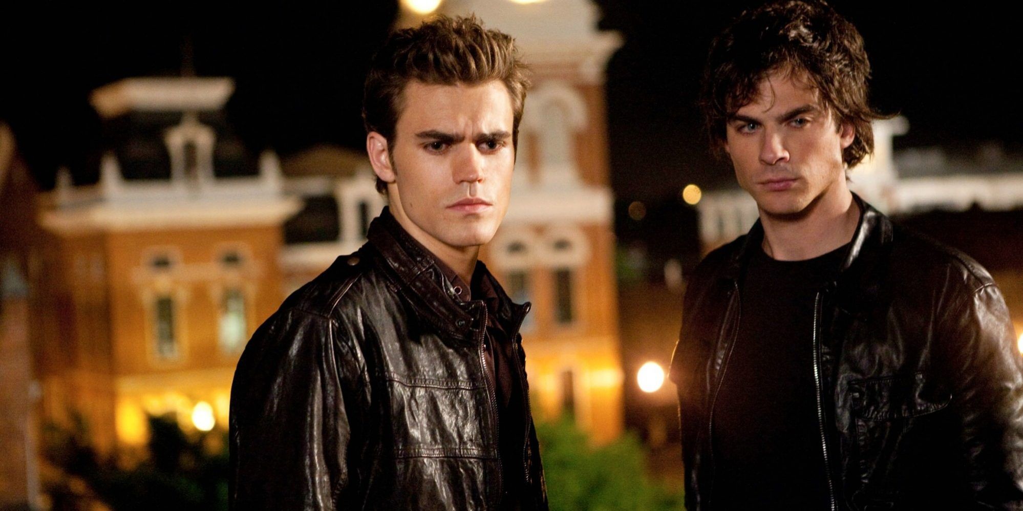 Stefan and Damon wearing leather jackets looking over Mystic Falls 