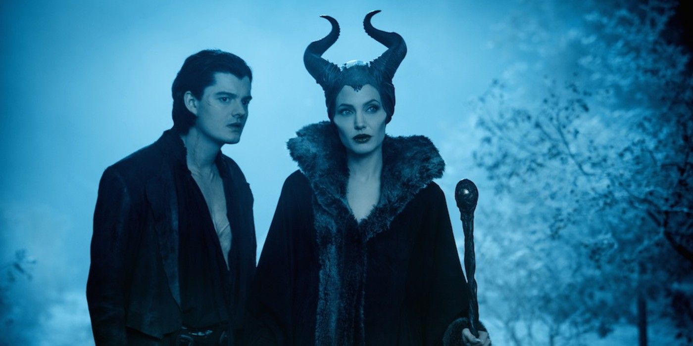 Maleficent standing with Diaval in the Moors