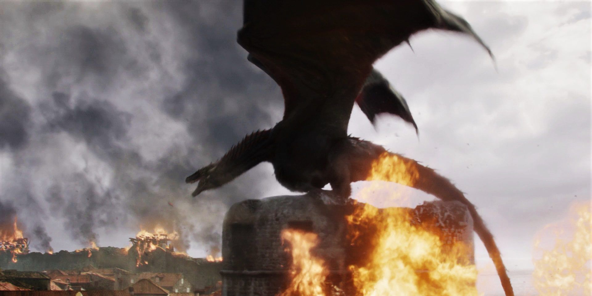 Drogon perched on a flaming building