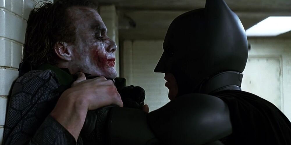 Batman interrogates Joker at the police station to find out where he took Harvey Dent and Rachel in The Dark Knight