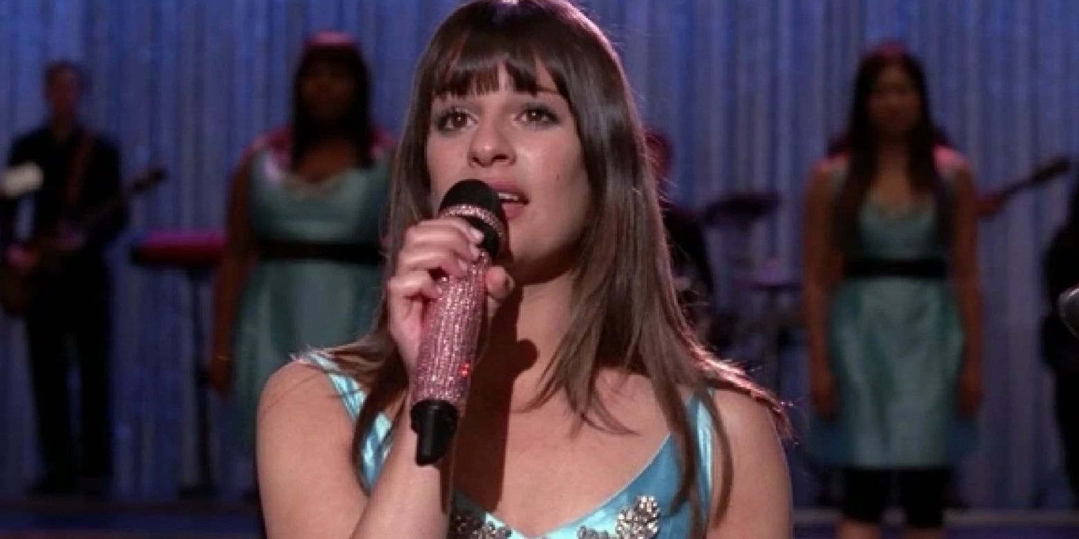 Rachel Berry sings with a microphone onstage in Glee