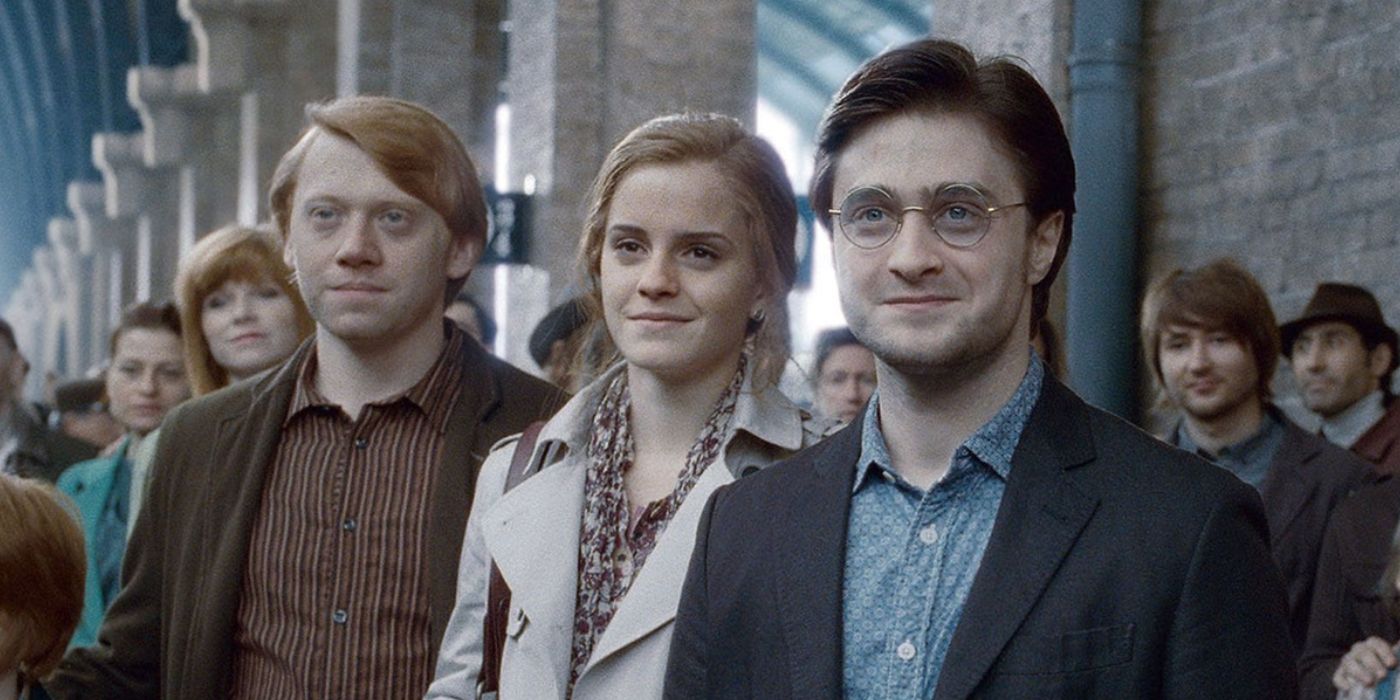 Harry, Ron, and Hermione standing on Platform 9 3/4  as adults in Harry Potter. 