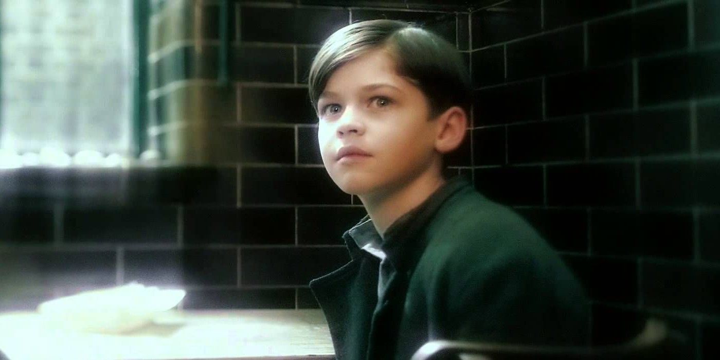 Young Tom Riddle sitting in his orphanage in Harry Potter Half Blood Prince.