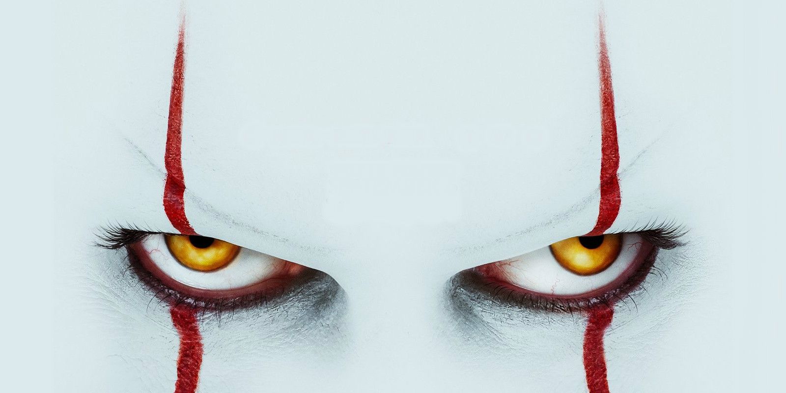 Pennywise's evil eyes glaring in the It Poster