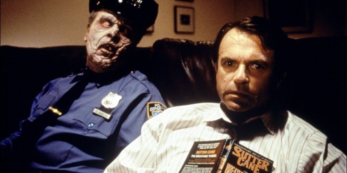Sam Neill sits next to a zombie in In The Mouth of Madness