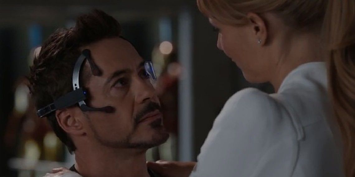 Tony Stark wearing a headset and talking to Pepper in Iron Man 3