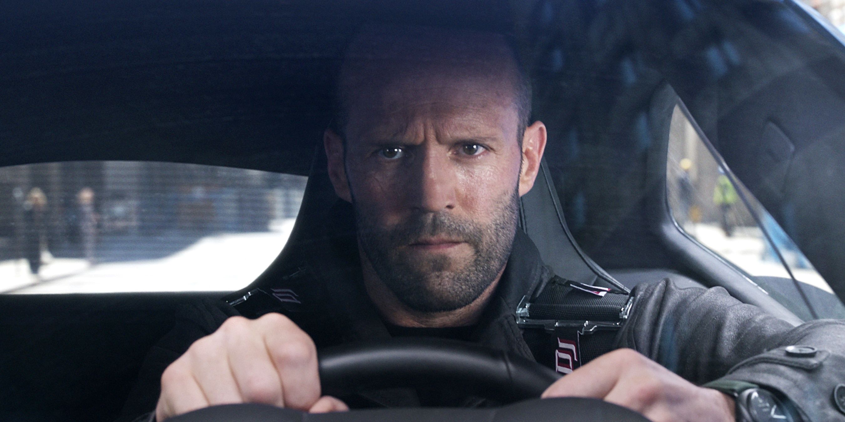 Jason Statham as Deckard Shaw driving a car